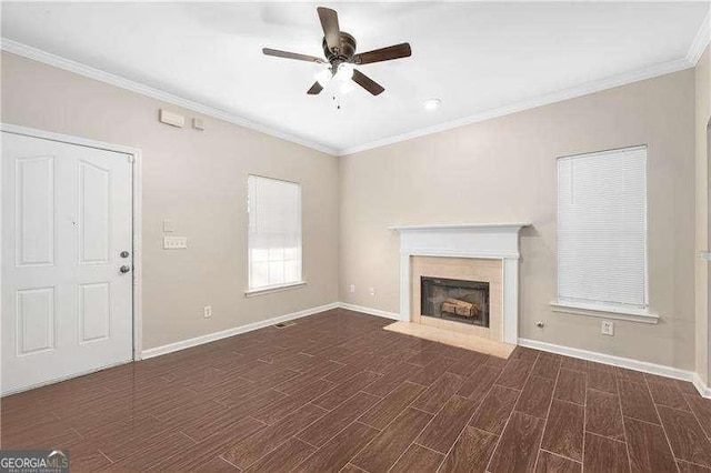 unfurnished living room with ceiling fan, ornamental molding, and dark hardwood / wood-style floors