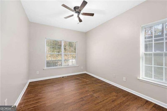 unfurnished room featuring dark hardwood / wood-style flooring and ceiling fan