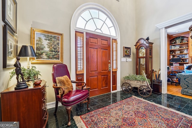 foyer entrance featuring a towering ceiling