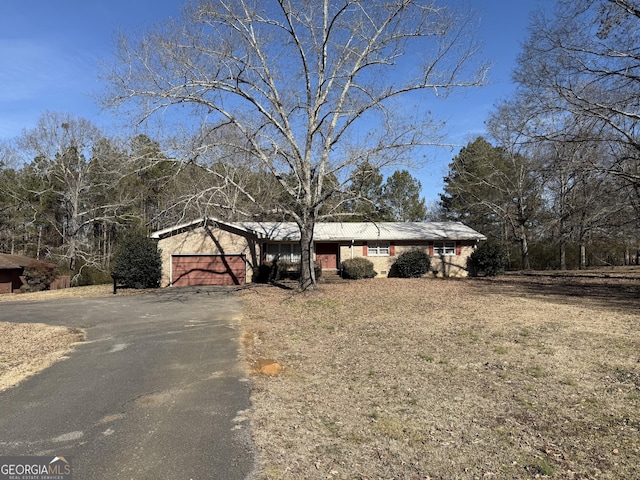 view of front of home with a garage and a front lawn