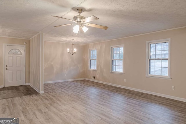 unfurnished room with crown molding, hardwood / wood-style floors, ceiling fan with notable chandelier, and a textured ceiling