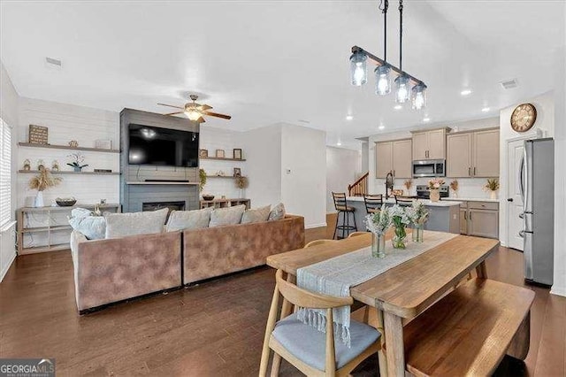 dining area featuring dark wood-type flooring and ceiling fan