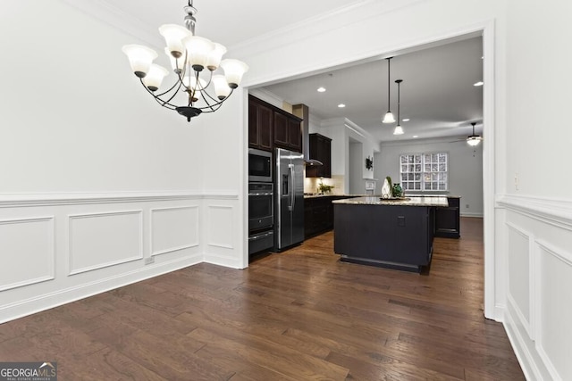 kitchen featuring hanging light fixtures, crown molding, stainless steel appliances, and a kitchen island