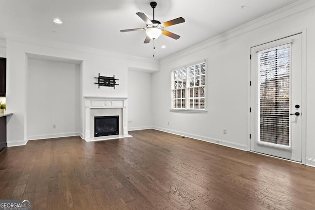 unfurnished living room featuring ceiling fan, crown molding, and dark hardwood / wood-style floors