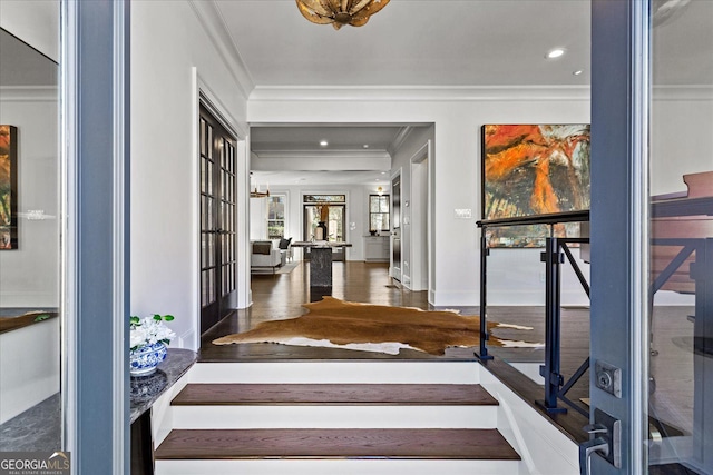 interior space with crown molding and dark hardwood / wood-style flooring