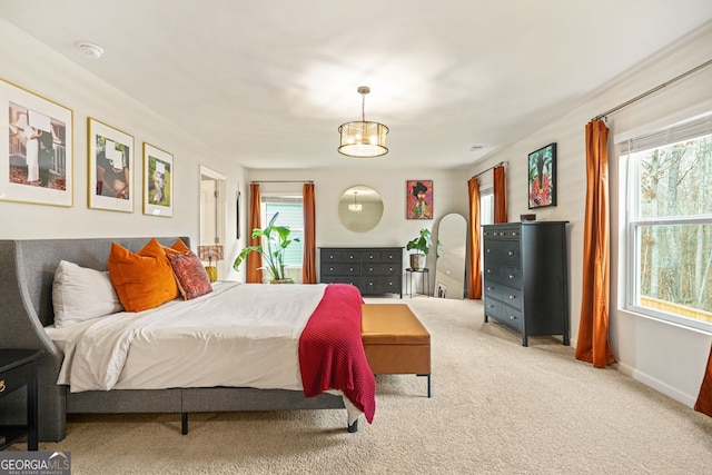 carpeted bedroom with multiple windows