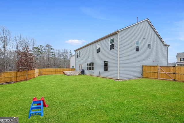 rear view of property with a yard