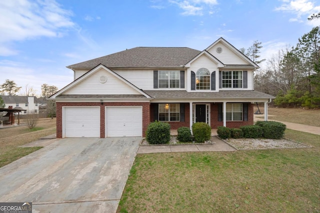 view of property with a garage, a front yard, and a porch