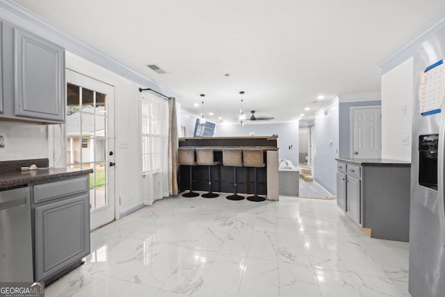 kitchen featuring crown molding, stainless steel dishwasher, gray cabinets, pendant lighting, and ceiling fan