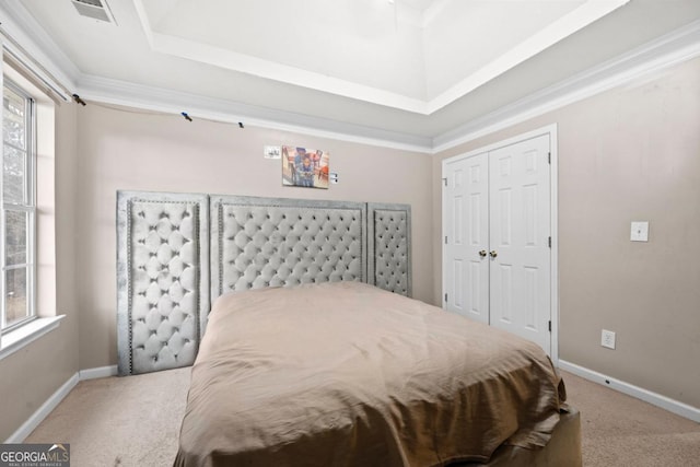 bedroom with ornamental molding, carpet, and a closet