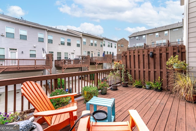 wooden terrace with a residential view and fence