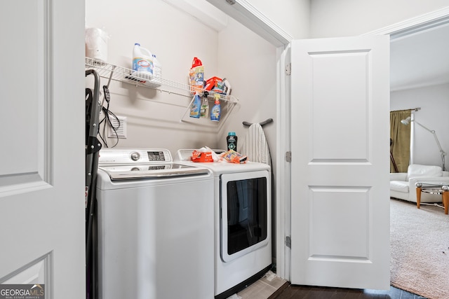 washroom featuring washing machine and dryer, laundry area, and dark colored carpet