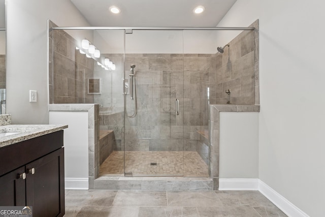 bathroom with recessed lighting, vanity, and a stall shower