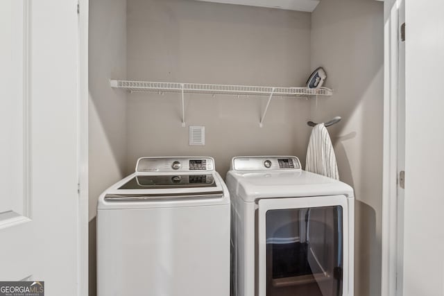 laundry room with laundry area and washer and clothes dryer
