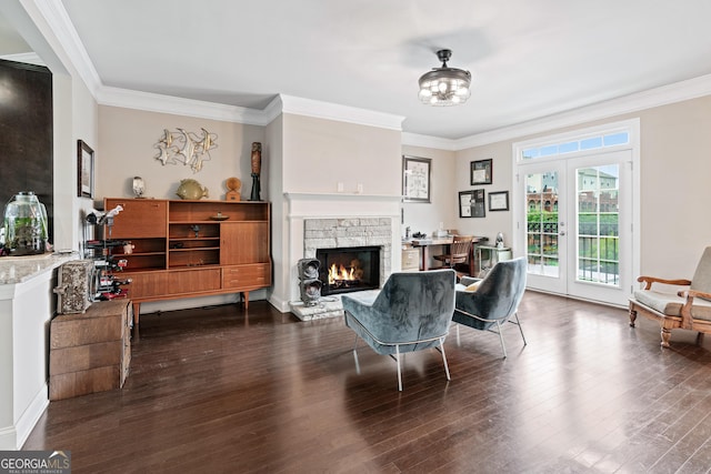 living area with ornamental molding, french doors, a fireplace, and wood finished floors