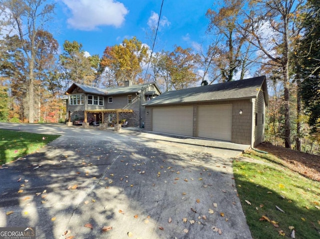 view of front of home featuring a garage and an outdoor structure