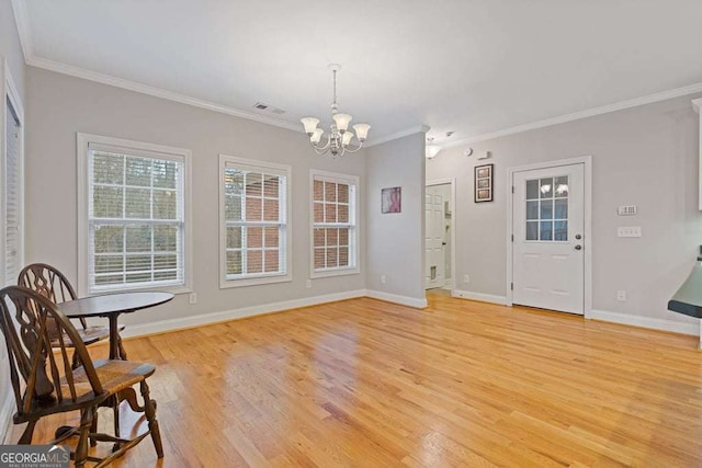 living area featuring a notable chandelier, crown molding, and light wood-type flooring