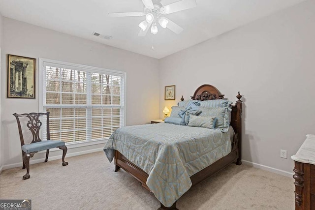 bedroom with light carpet and ceiling fan