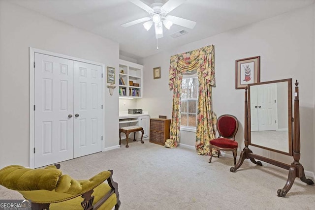 sitting room with light carpet and ceiling fan