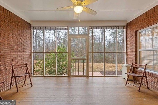 sunroom / solarium featuring ceiling fan