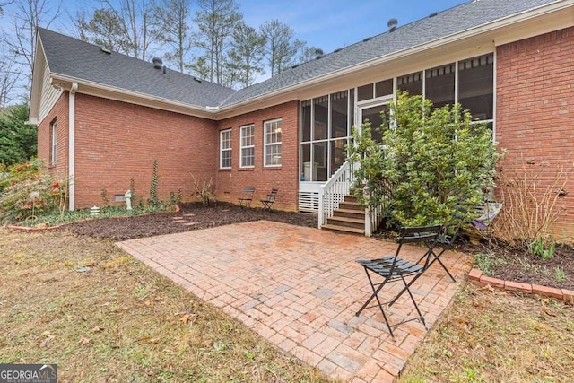 rear view of property featuring a patio and a sunroom