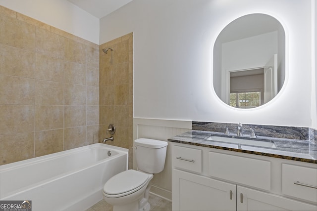 bathroom with a wainscoted wall, shower / bath combination, vanity, and toilet