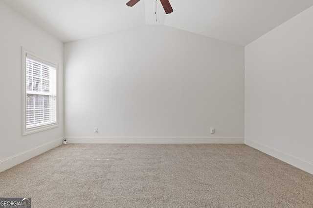 unfurnished room featuring lofted ceiling, carpet flooring, ceiling fan, and baseboards