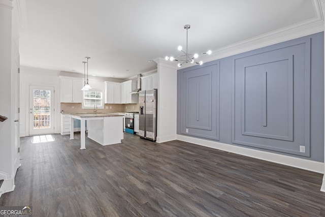 kitchen featuring a breakfast bar, hanging light fixtures, white cabinets, a kitchen island, and gas range