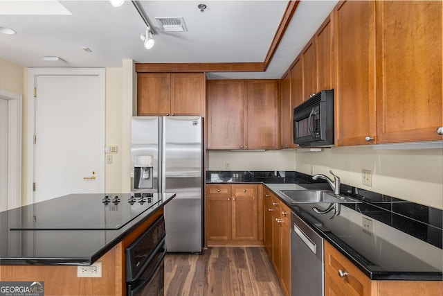 kitchen featuring sink, dark wood-type flooring, and black appliances