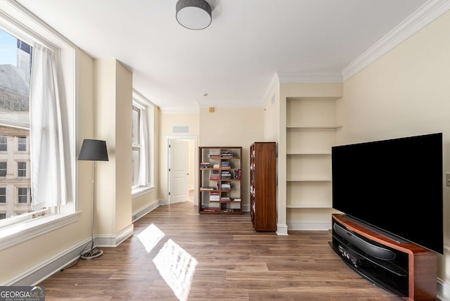 living room featuring dark wood-type flooring and ornamental molding