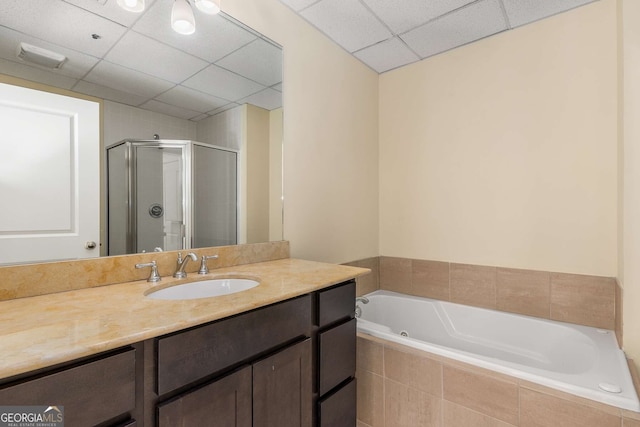 bathroom featuring vanity, a paneled ceiling, and separate shower and tub