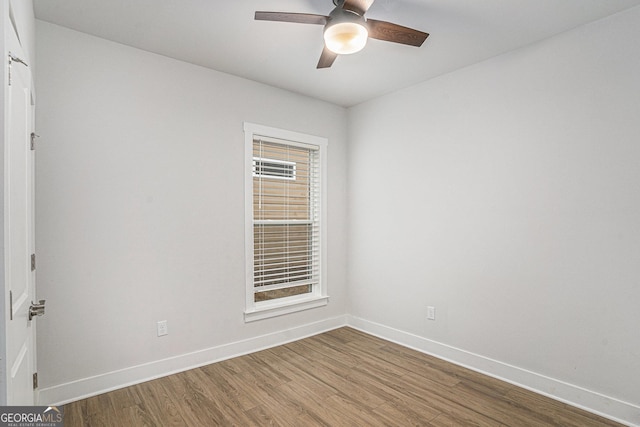 unfurnished room with ceiling fan and hardwood / wood-style floors