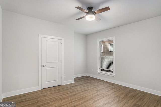 spare room featuring hardwood / wood-style floors and ceiling fan