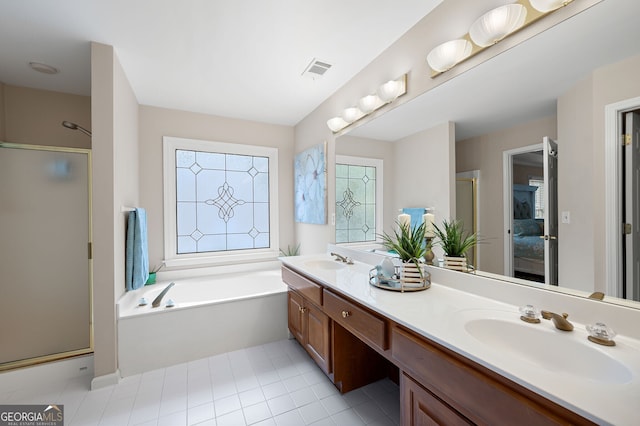 bathroom featuring tile patterned floors, vanity, and shower with separate bathtub