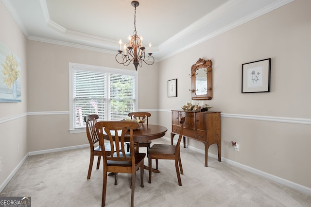 dining room with an inviting chandelier, light colored carpet, and crown molding