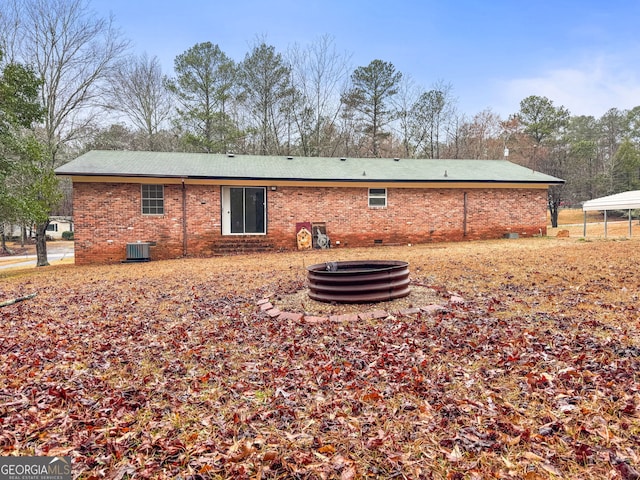 back of house with central AC unit