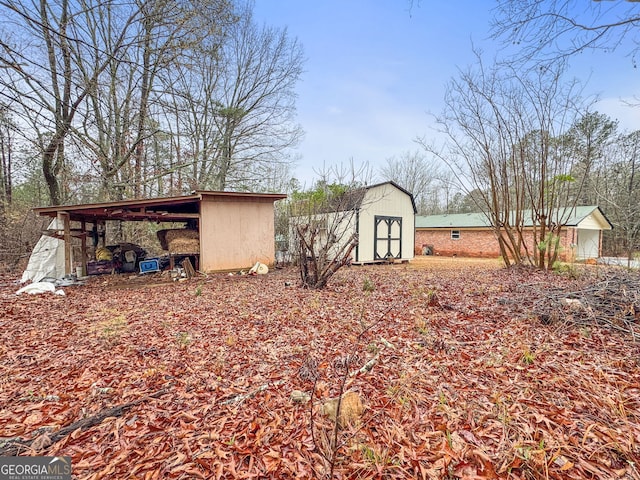 exterior space with a storage shed and a carport