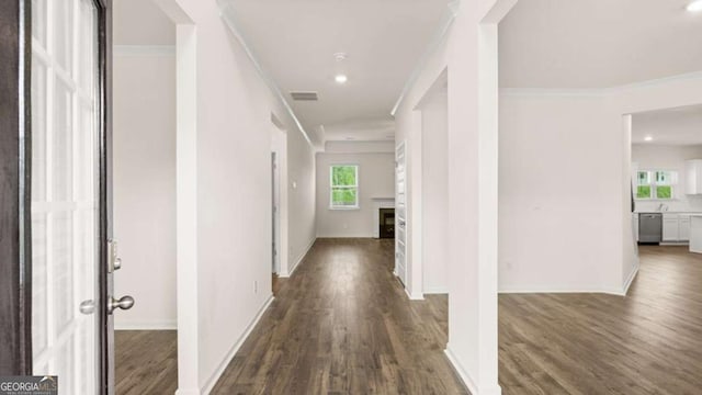 hall featuring ornamental molding and dark hardwood / wood-style flooring