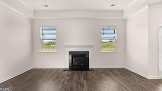 unfurnished living room featuring dark wood-type flooring, a wealth of natural light, and ornamental molding