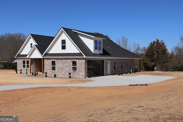 rear view of house with brick siding