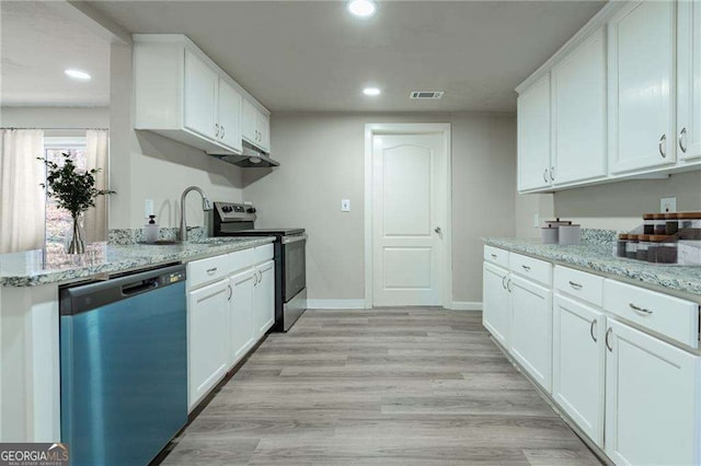 kitchen with white cabinetry, appliances with stainless steel finishes, light stone counters, and light hardwood / wood-style floors