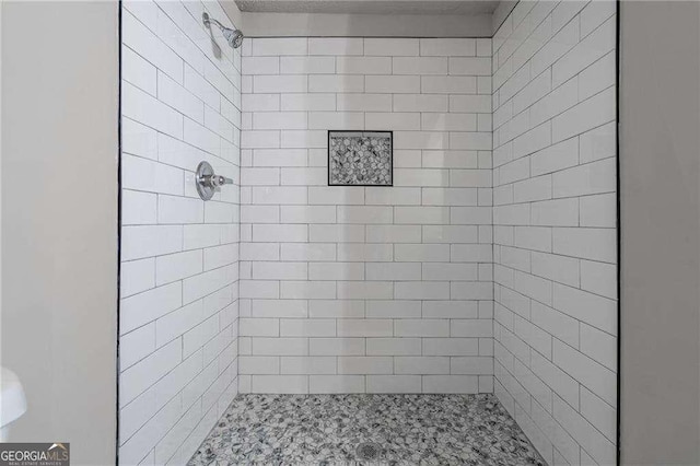 bathroom with a tile shower