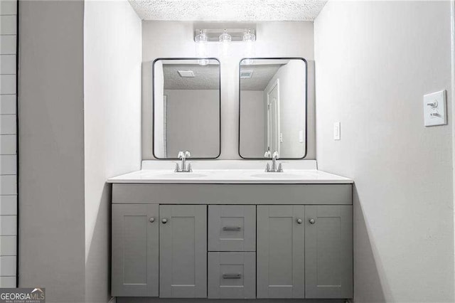 bathroom featuring vanity and a textured ceiling