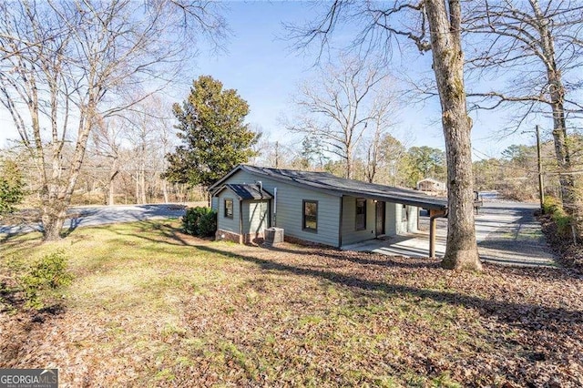 exterior space featuring central AC and a lawn