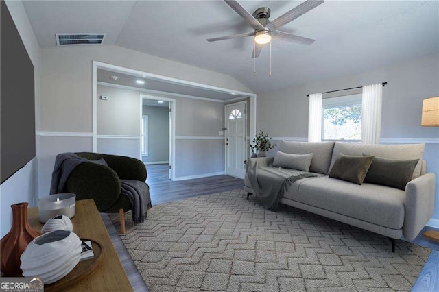 living room featuring light hardwood / wood-style flooring, vaulted ceiling, and ceiling fan