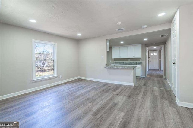 unfurnished living room with light hardwood / wood-style flooring