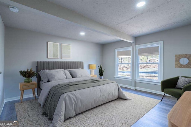 bedroom featuring hardwood / wood-style flooring and a textured ceiling