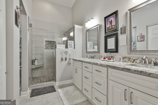 bathroom featuring vanity, tile patterned flooring, and a shower with shower door