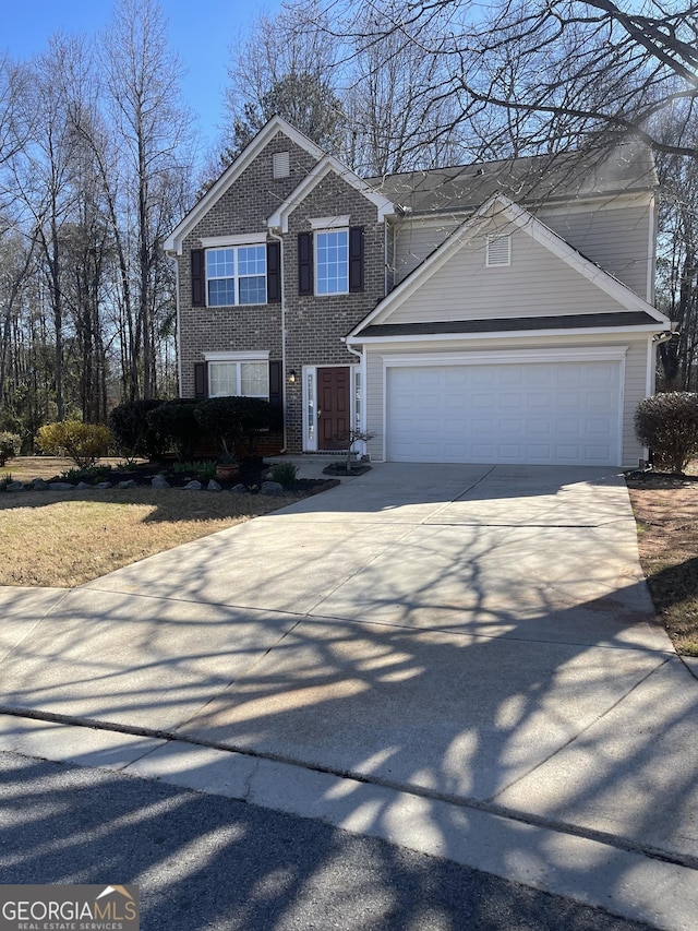 view of front of house with brick siding, driveway, and an attached garage