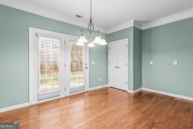 100 Windmeadow Way, Fayetteville, GA 30214 - unfurnished dining area featuring a chandelier, ornamental molding, baseboards, and wood finished floors